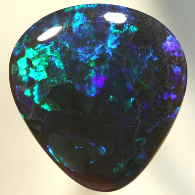 SOLID BLACK CRYSTAL OPAL Bright greens play over a background hue of purple blue SEE VIDEO